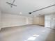 Spacious garage featuring gray epoxy floors, white walls, a ceiling mounted garage door opener, and a door at 4239 Newcomb Rd, Decatur, GA 30034
