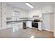 Well-lit kitchen featuring white cabinets, stainless steel appliances, and a center island at 4239 Newcomb Rd, Decatur, GA 30034