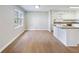 Sun-filled kitchen and living space with new floors and paint, island, and ample room for dining and entertaining at 4239 Newcomb Rd, Decatur, GA 30034