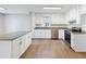 Bright kitchen featuring white cabinets, stainless steel appliances, modern countertops, and an island at 4239 Newcomb Rd, Decatur, GA 30034