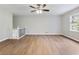 Cozy living area with hardwood floors, a ceiling fan, and windows that allow natural light to create a warm ambiance at 4239 Newcomb Rd, Decatur, GA 30034