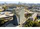 A stunning aerial view of a glass high-rise in an urban setting with city skyline and trees at 788 W Marietta Nw St # 913, Atlanta, GA 30318