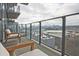 Balcony featuring modern patio furniture and a glass railing with a distant city skyline view at 788 W Marietta Nw St # 913, Atlanta, GA 30318