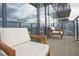 Relaxing balcony with chairs, offering a stunning city view through glass railings and a glimpse of a contemporary building at 788 W Marietta Nw St # 913, Atlanta, GA 30318