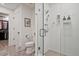 Bathroom featuring a toilet, glass-enclosed shower with white tile, and a doorway leading to a walk-in closet at 788 W Marietta Nw St # 913, Atlanta, GA 30318