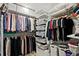 Spacious walk-in closet with organized clothing racks, shelves, storage containers and neatly stacked pillows at 788 W Marietta Nw St # 913, Atlanta, GA 30318