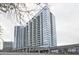 Modern condo building with parking garage entrance, street-level retail, and sleek glass facade at 788 W Marietta Nw St # 913, Atlanta, GA 30318
