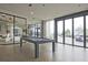 Bright game room features a pool table, floor-to-ceiling windows and access to the outdoor lounge at 788 W Marietta Nw St # 913, Atlanta, GA 30318