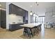 Modern kitchen with dark cabinetry, quartz countertops, a large island, and stainless steel appliances at 788 W Marietta Nw St # 913, Atlanta, GA 30318