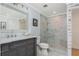 Primary bath with gray vanity, glass shower, and marble tile at 1516 Ashford Club Ne Ct, Brookhaven, GA 30319