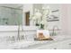 Close-up view of a bathroom's dual marble vanity and modern fixtures at 1516 Ashford Club Ne Ct, Brookhaven, GA 30319