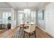 Elegant dining room featuring a modern chandelier, large windows, and access to the outdoors at 1516 Ashford Club Ne Ct, Brookhaven, GA 30319