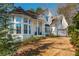 Detailed view of white brick home featuring a turret and attached garage at 1516 Ashford Club Ne Ct, Brookhaven, GA 30319