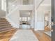 Bright foyer with hardwood floors, staircase, and views into the formal living area at 1516 Ashford Club Ne Ct, Brookhaven, GA 30319