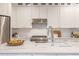 Modern kitchen featuring white cabinets, stainless steel appliances, and a stylish countertop at 1516 Ashford Club Ne Ct, Brookhaven, GA 30319