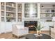 Cozy living room detail showcasing a fireplace with built-in shelving and a comfortable armchair at 1516 Ashford Club Ne Ct, Brookhaven, GA 30319