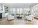 Bright living room with large windows and hardwood flooring throughout at 1516 Ashford Club Ne Ct, Brookhaven, GA 30319