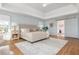 Well-lit main bedroom features a tray ceiling, seating area and hardwood floors at 1516 Ashford Club Ne Ct, Brookhaven, GA 30319