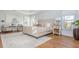 Bright and airy main bedroom with large windows, hardwood floors and a seating area at 1516 Ashford Club Ne Ct, Brookhaven, GA 30319