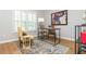 Home office with natural light from shuttered windows, hardwood floors, and stylish decor at 1516 Ashford Club Ne Ct, Brookhaven, GA 30319