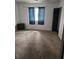 Neutral bedroom with a black dresser, blue curtains, plush carpeting and ample natural light at 135 Windy Hill Rd, Fayetteville, GA 30214