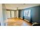 A spacious bedroom with hardwood floors, soft gray paint and a ceiling fan at 135 Windy Hill Rd, Fayetteville, GA 30214