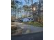 A sprawling home with a long driveway nestled among mature pine trees at 135 Windy Hill Rd, Fayetteville, GA 30214