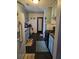 A galley kitchen features vintage light blue cabinets and modern black appliances at 135 Windy Hill Rd, Fayetteville, GA 30214