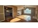 Open-concept view of the living room with fireplace and vaulted ceiling, which transitions to the kitchen with white cabinets at 27 Sunrise Ct, Dallas, GA 30157