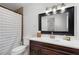 Bathroom with vanity, mirror, and shower with tile surround at 4122 Antler Se Trl, Smyrna, GA 30082