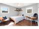 Cozy bedroom with ample natural light, hardwood floors, and seating area at 4122 Antler Se Trl, Smyrna, GA 30082