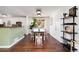 Dining room with a dark wood table, light wood chairs, and stylish décor, with view to kitchen at 4122 Antler Se Trl, Smyrna, GA 30082