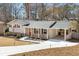 Charming home featuring a brick facade, covered carport, and a well-manicured front yard with a concrete driveway at 4122 Antler Se Trl, Smyrna, GA 30082