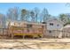 Home's back exterior features a deck, siding, and brick for outdoor living at 4122 Antler Se Trl, Smyrna, GA 30082