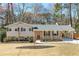 Charming single-Gathering home featuring a well-maintained lawn, brick accents, and a convenient carport at 4122 Antler Se Trl, Smyrna, GA 30082