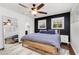 Comfortable main bedroom features a ceiling fan, full-length mirror, and a black accent wall at 4122 Antler Se Trl, Smyrna, GA 30082