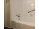 Clean bathroom with a white tiled shower/tub, grab bar and updated fixtures at 2917 Toney Dr, Decatur, GA 30032