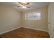 Neutral bedroom featuring hardwood floors, neutral walls and fan; well-lit by window at 2917 Toney Dr, Decatur, GA 30032