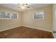Bright bedroom with hardwood floors, two windows, and neutral paint, creating a serene atmosphere at 2917 Toney Dr, Decatur, GA 30032