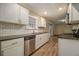 Modern kitchen boasting stainless steel appliances, white cabinets, and wood-look floors at 2917 Toney Dr, Decatur, GA 30032