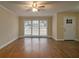 Bright living room with hardwood floors, a large window with blinds and a white door at 2917 Toney Dr, Decatur, GA 30032