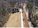 Aerial view of a modern farmhouse on large lot with a long driveway at 7760 E Cherokee Dr, Canton, GA 30115
