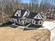 Aerial view of a modern farmhouse with a striking roofline and long driveway at 7760 E Cherokee Dr, Canton, GA 30115