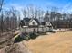 Beautiful two-story farmhouse with a welcoming front porch and landscaped front yard at 7760 E Cherokee Dr, Canton, GA 30115