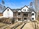 Rear view of a two-story home with a walkout basement and elevated wooden deck at 7760 E Cherokee Dr, Canton, GA 30115