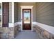 A craftsman-style front door with decorative glass, sidelights, and stone accents for enhanced curb appeal at 804 White St, Villa Rica, GA 30180