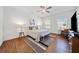 Spacious main bedroom featuring a ceiling fan, wood floors, natural light, and seating area at 804 White St, Villa Rica, GA 30180