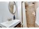 Modern bathroom featuring a shower with tile, a mirror, and stylish vanity at 2312 Wayside Ne Dr, Brookhaven, GA 30319