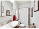 A bright bathroom featuring tile flooring, a shower with a white shower curtain, and a cherry vanity at 2312 Wayside Ne Dr, Brookhaven, GA 30319