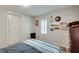 Comfortable bedroom featuring a dresser, bed with decor, and ample natural light from the two windows at 2312 Wayside Ne Dr, Brookhaven, GA 30319